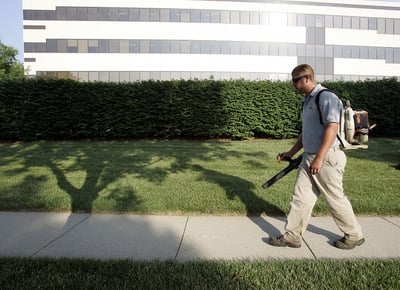 landscape employee using leaf blower